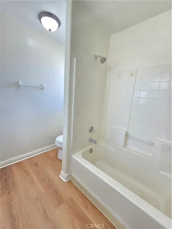 a spacious bathroom with a bathtub sink and mirror