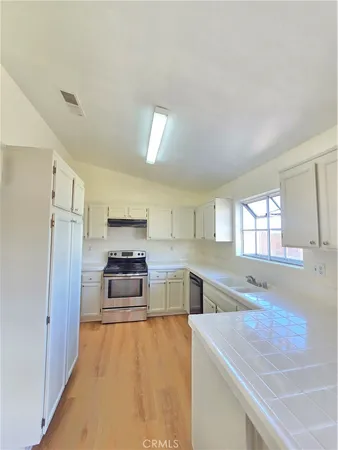 a kitchen with granite countertop a stove and a sink