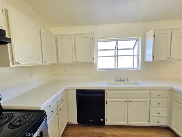 a kitchen with white cabinets and a sink