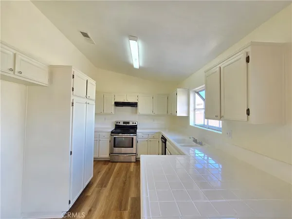 a kitchen with stainless steel appliances a refrigerator sink and stove