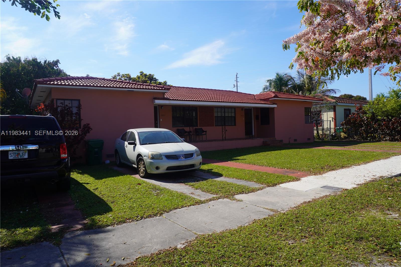 a front view of a house with a garden and yard