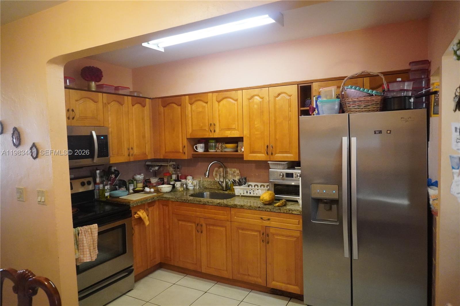 2660 Southwest 36th Avenue Miami, FL 33133 - Photo 16 of 32 a kitchen with stainless steel appliances granite countertop a refrigerator and a sink
