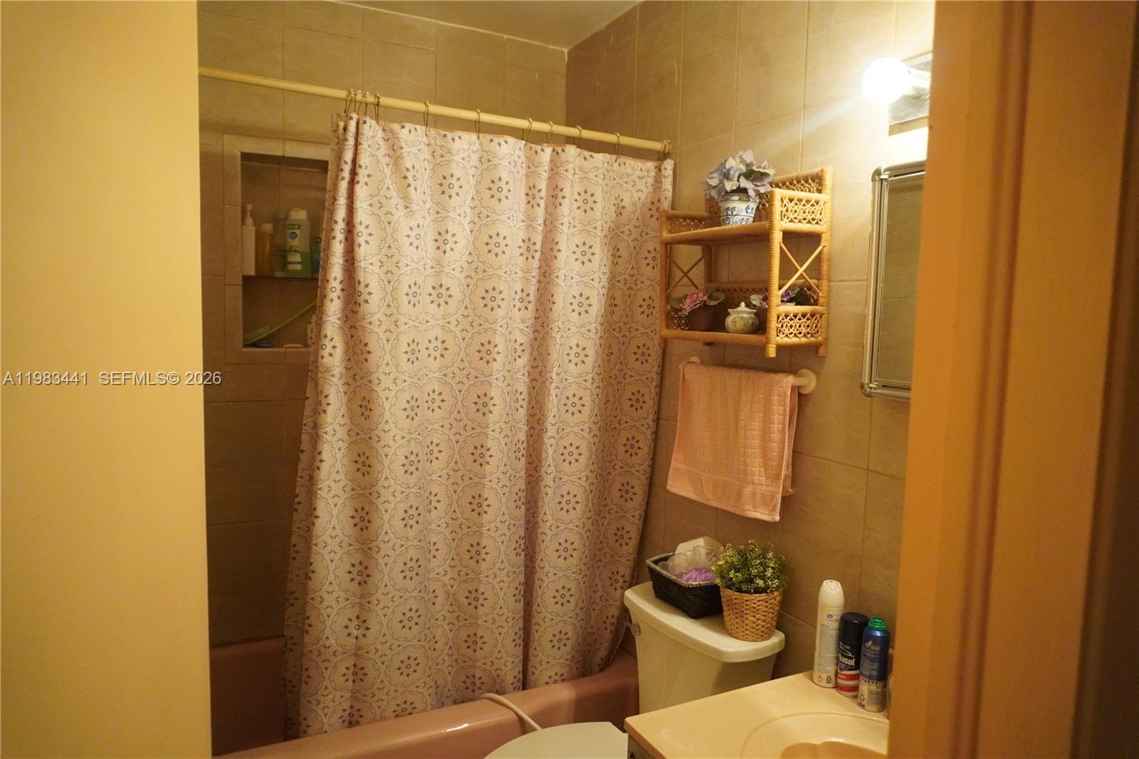2660 Southwest 36th Avenue Miami, FL 33133 - Photo 19 of 32 a bathroom with a shower curtain and a window
