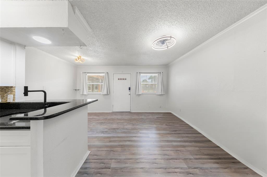 2401 Manor Road, Unit 123 Austin, TX 78722 - Photo 6 of 22 Granite counters and wood flooring provide a harmonious blend of style and durability.