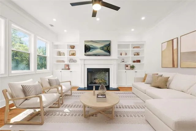 a living room with furniture a fireplace and a flat screen tv