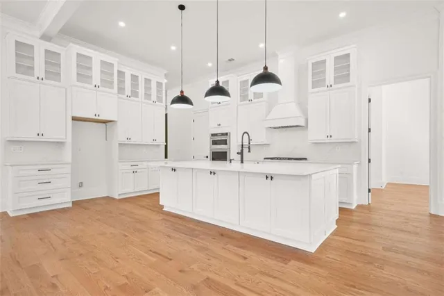 a spacious bedroom with a large bed and a flat screen tv