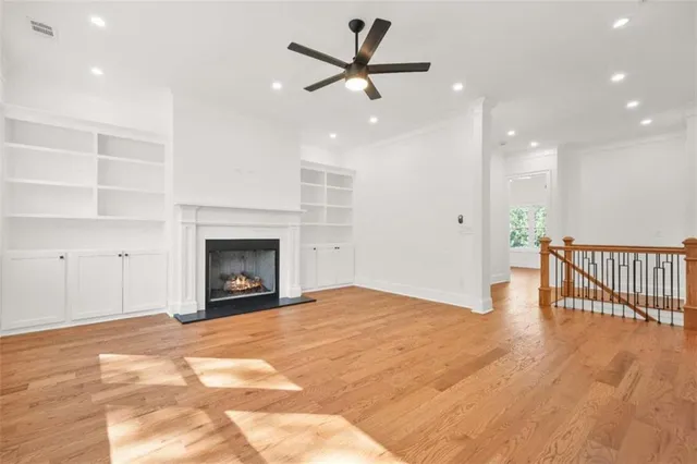 a kitchen with a wooden floor and white walls