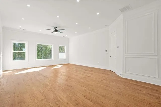 a view of empty room with wooden floor