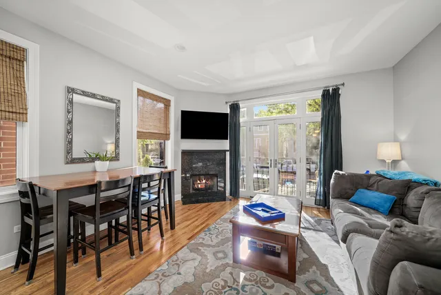 a living room with furniture a fireplace and a flat screen tv
