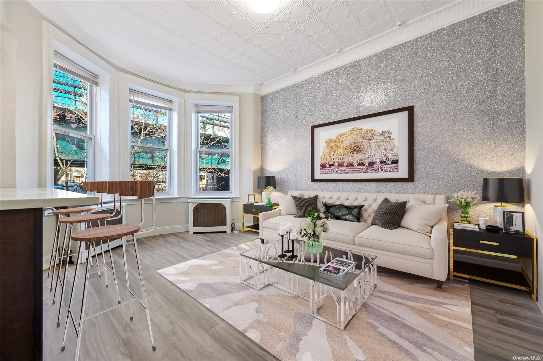 60-71 67th Avenue Queens, NY 11385 - Photo 1 of 1 a living room with furniture and a large window