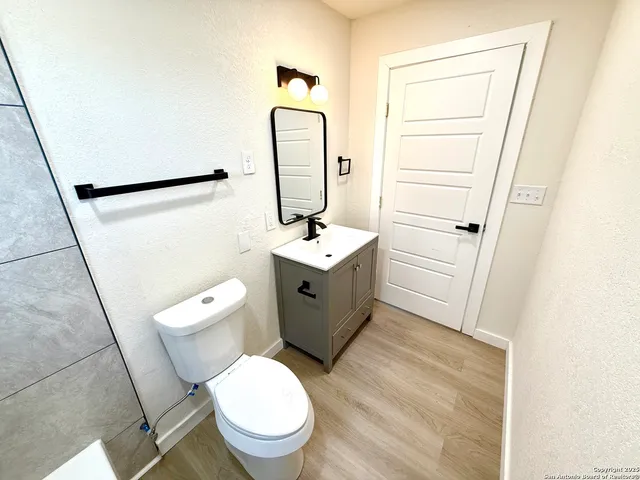 a white toilet sitting next to a bathroom sink