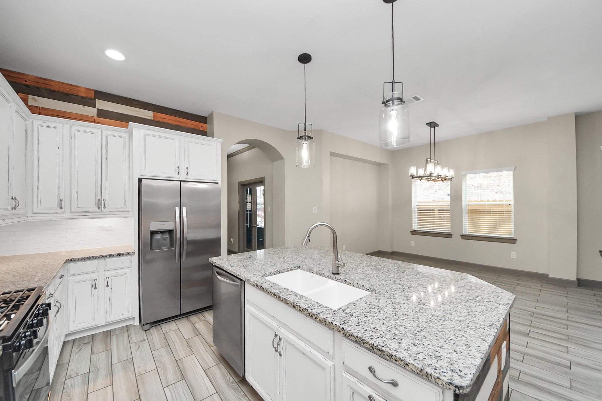 211 Pleasant Hill Way Conroe, TX 77304 - Photo 11 of 50 a kitchen with stainless steel appliances granite countertop a sink refrigerator and microwave