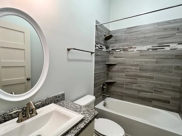 a bathroom with a sink toilet and shower