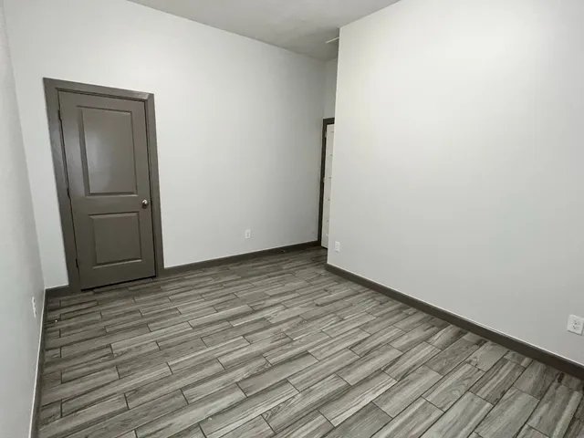 a view of wooden floor in an empty room
