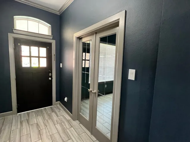 a view of a bedroom with wooden floor