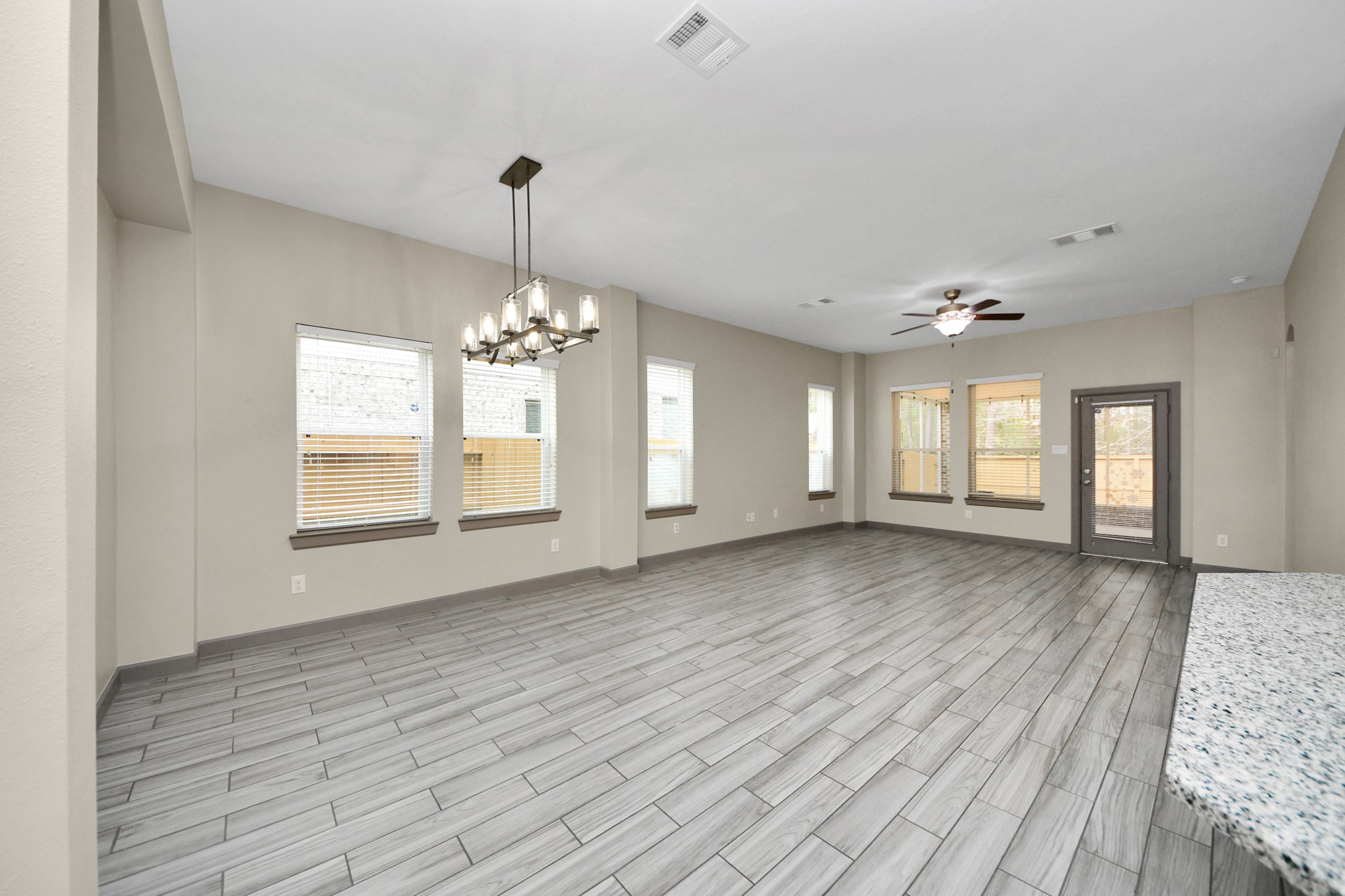 211 Pleasant Hill Way Conroe, TX 77304 - Photo 17 of 50 a view of an empty room with window and wooden floor