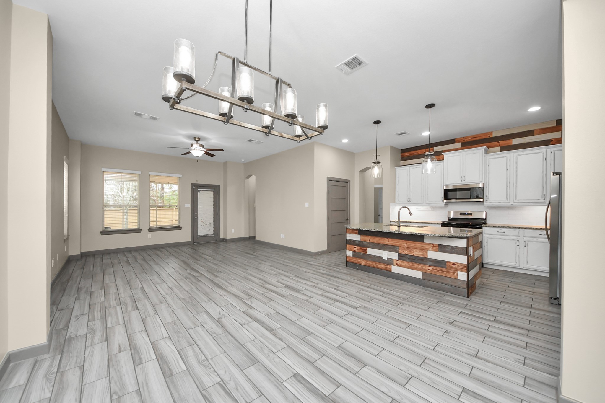 211 Pleasant Hill Way Conroe, TX 77304 - Photo 19 of 50 a kitchen with stainless steel appliances kitchen island hardwood floor and a sink