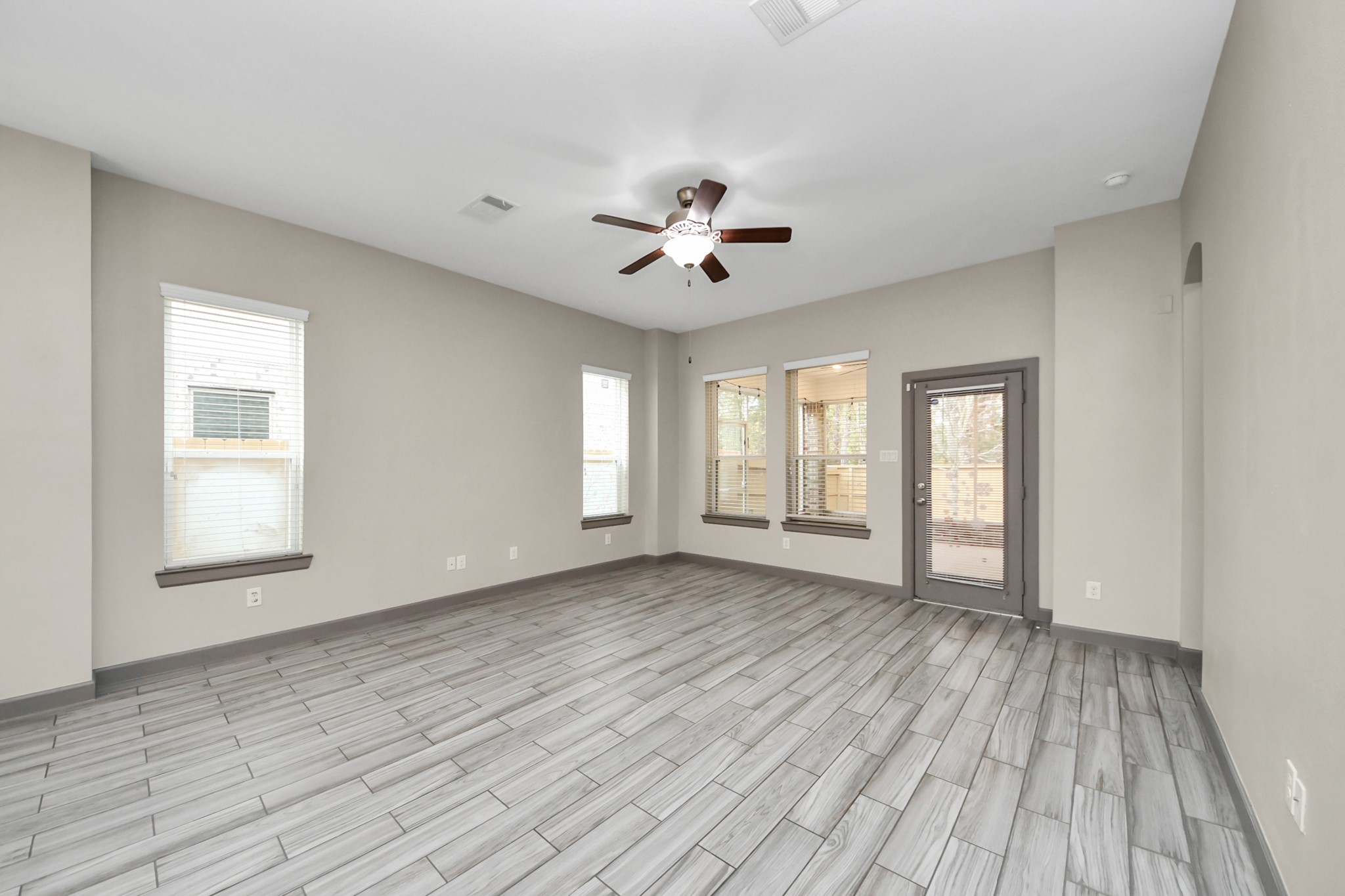 211 Pleasant Hill Way Conroe, TX 77304 - Photo 21 of 50 an empty room with wooden floor and windows