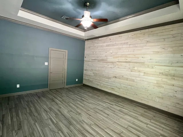 a view of empty room with wooden floor