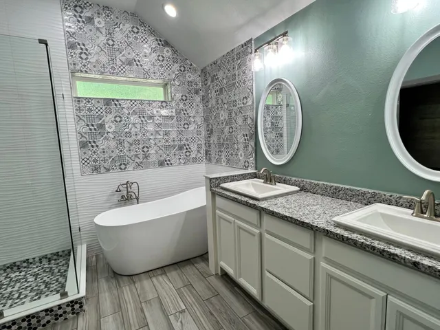 a spacious bathroom with a granite countertop sink and a mirror