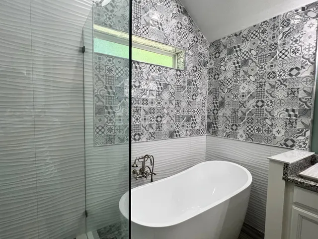 a bathroom with a bathtub and shower