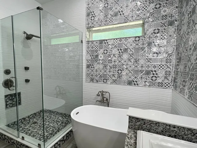 a bathroom with a bathtub and shower