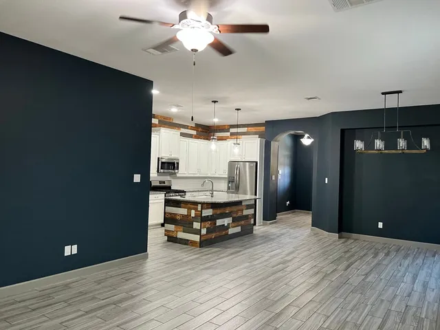 a living room with furniture and a chandelier