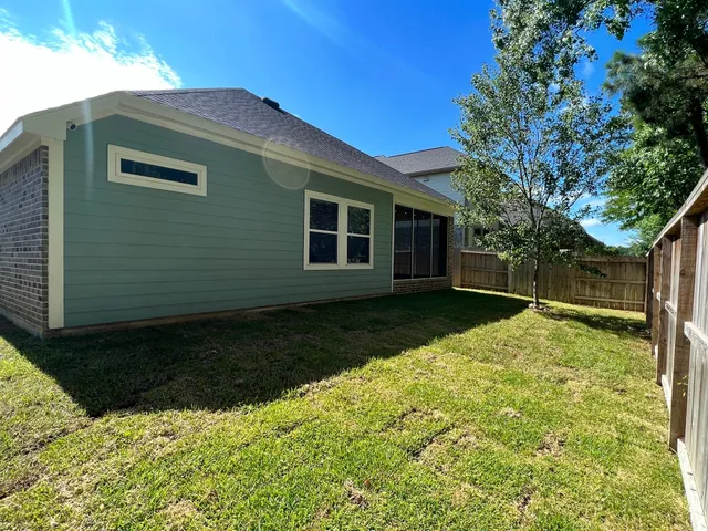 a backyard of a house with yard and outdoor seating