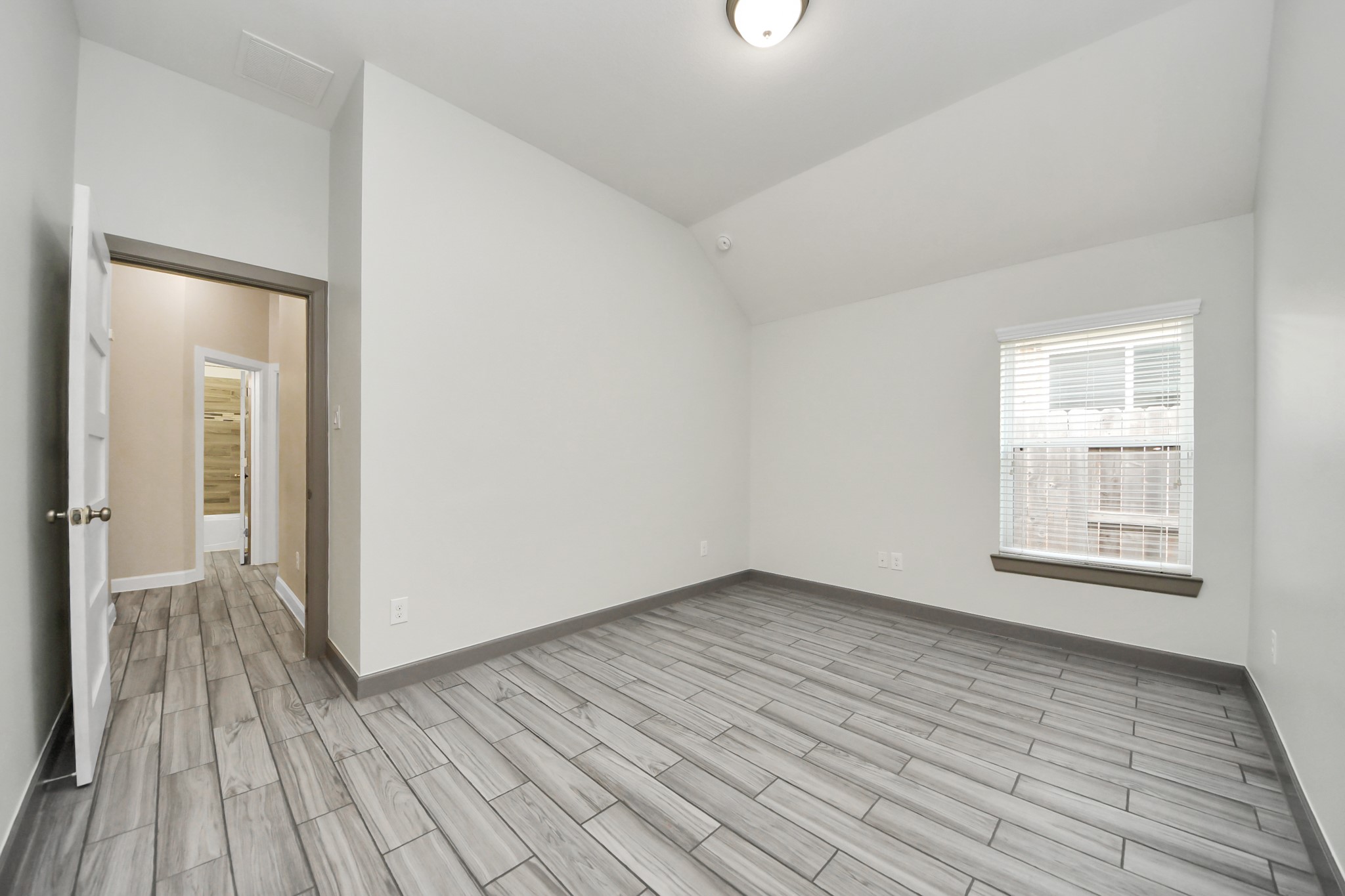 211 Pleasant Hill Way Conroe, TX 77304 - Photo 33 of 50 a view of an empty room with wooden floor and a window