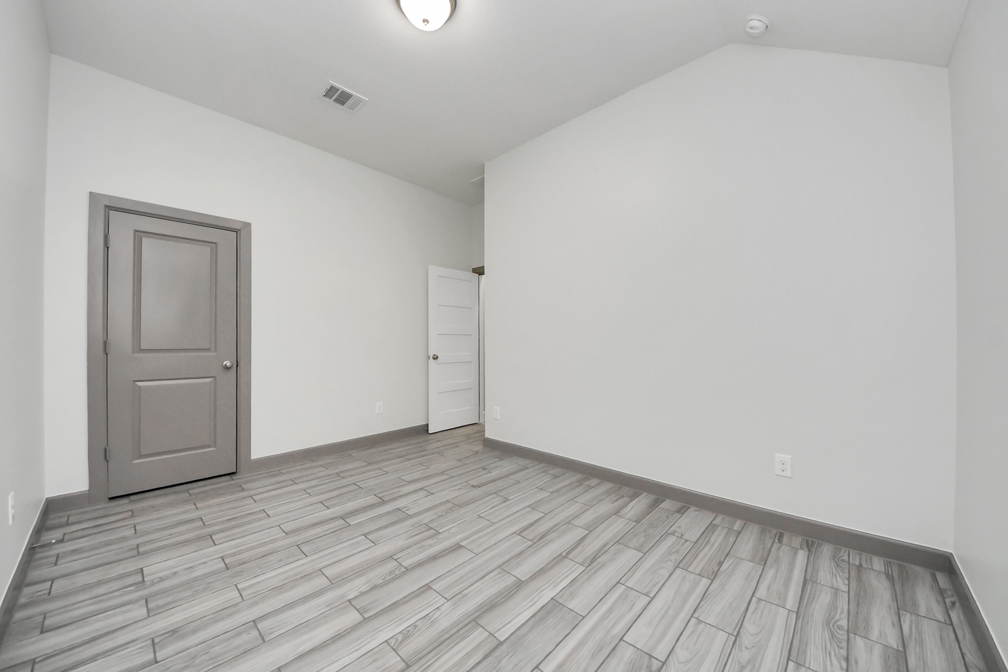 211 Pleasant Hill Way Conroe, TX 77304 - Photo 35 of 50 a view of an empty room and wooden floor