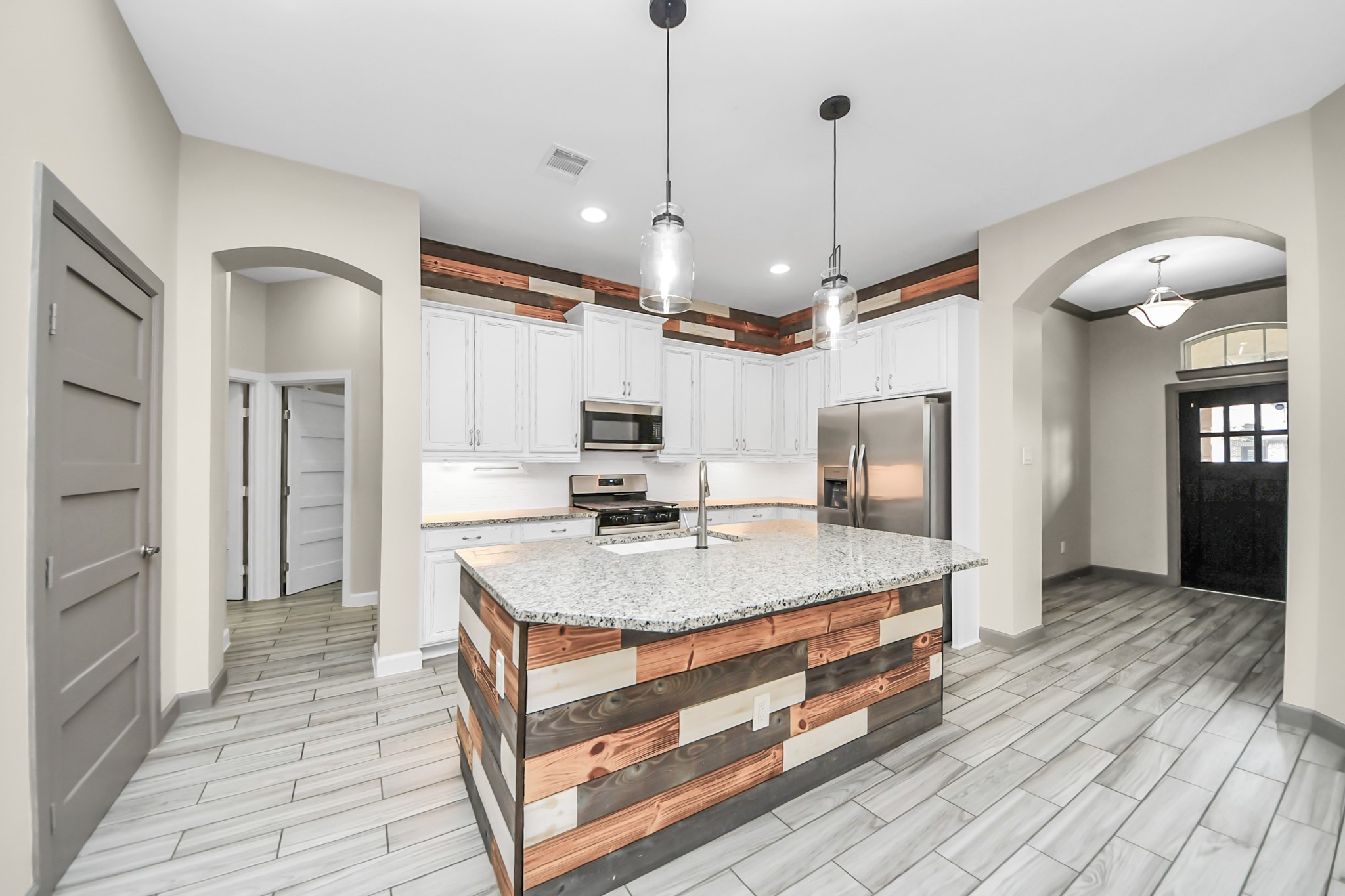 211 Pleasant Hill Way Conroe, TX 77304 - Photo 10 of 50 a kitchen with kitchen island a counter top space a sink appliances and cabinets