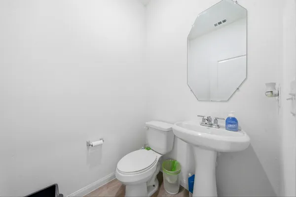 a bathroom with a sink mirror and toilet