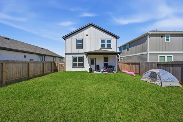 a view of a house with backyard and porch