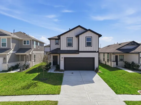 a front view of a house with a yard and garage