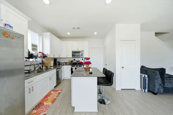a kitchen with refrigerator and cabinets