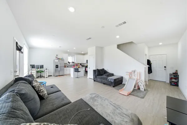 a living room with furniture and view of couch