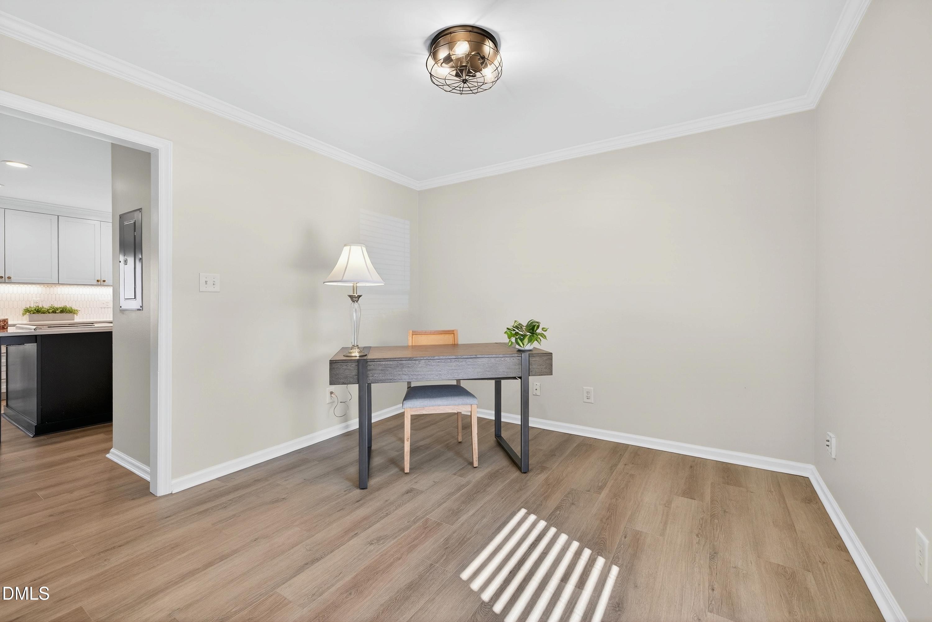 6009 Sweden Drive Raleigh, NC 27612 - Photo 14 of 38 a view of a workspace with furniture and wooden floor