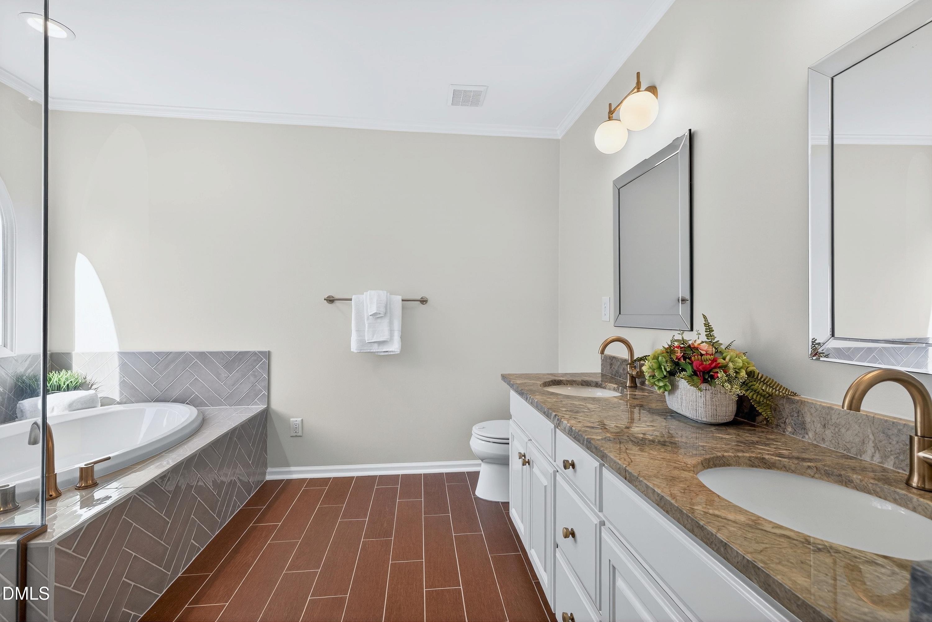 6009 Sweden Drive Raleigh, NC 27612 - Photo 19 of 38 a bathroom with a granite countertop sink a mirror and shower
