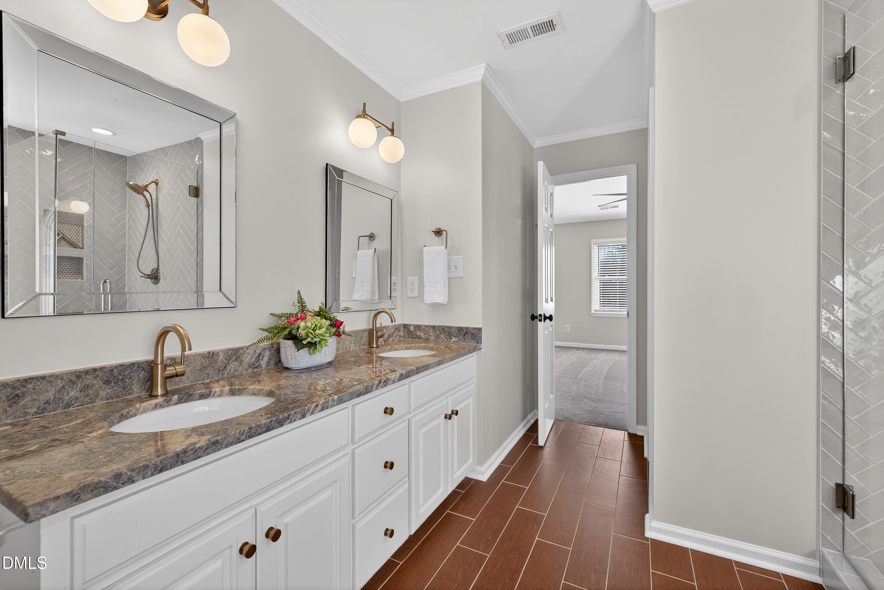 6009 Sweden Drive Raleigh, NC 27612 - Photo 21 of 38 a bathroom with a granite countertop double vanity sink and mirror