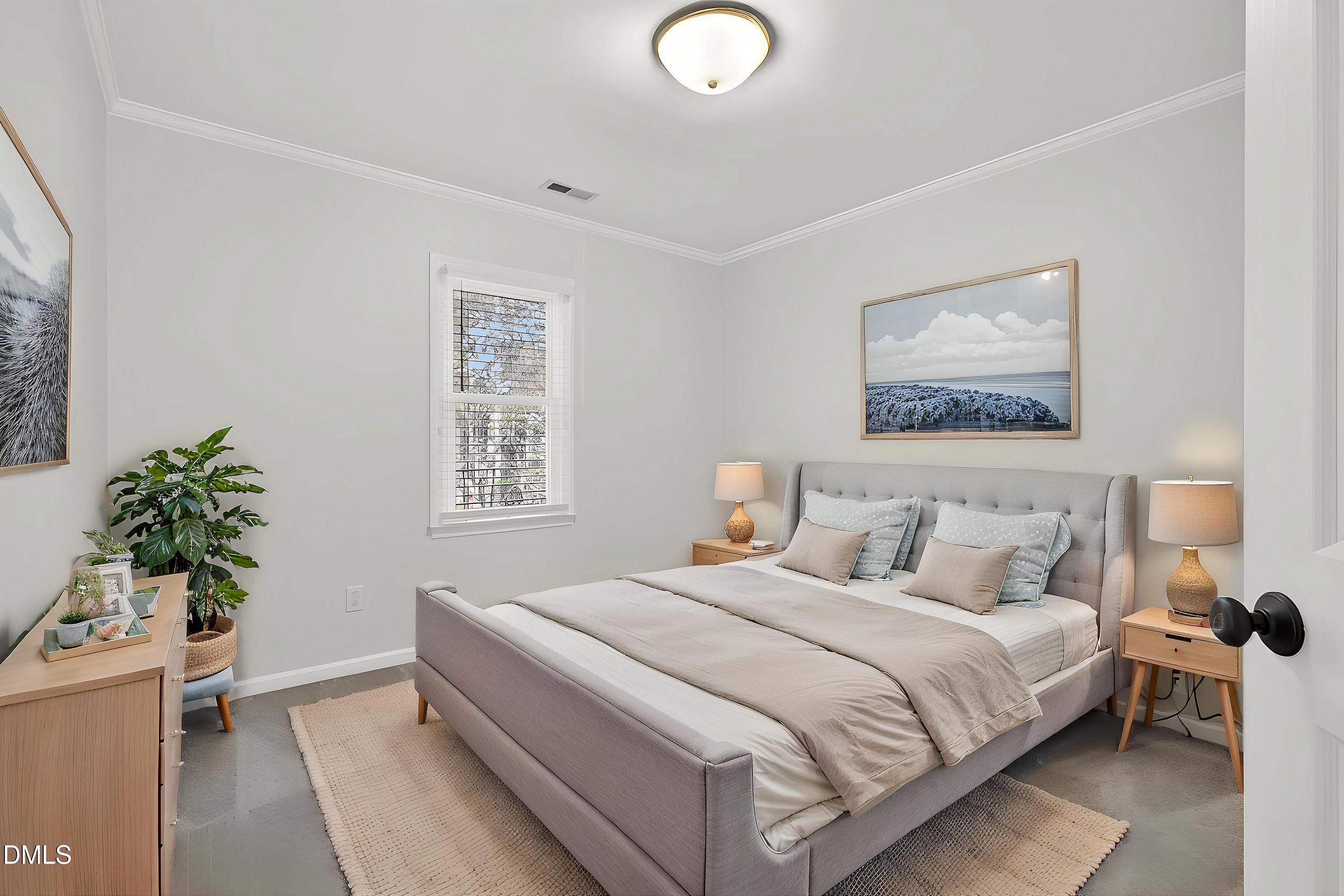 6009 Sweden Drive Raleigh, NC 27612 - Photo 27 of 38 a bedroom with a bed and a potted plant