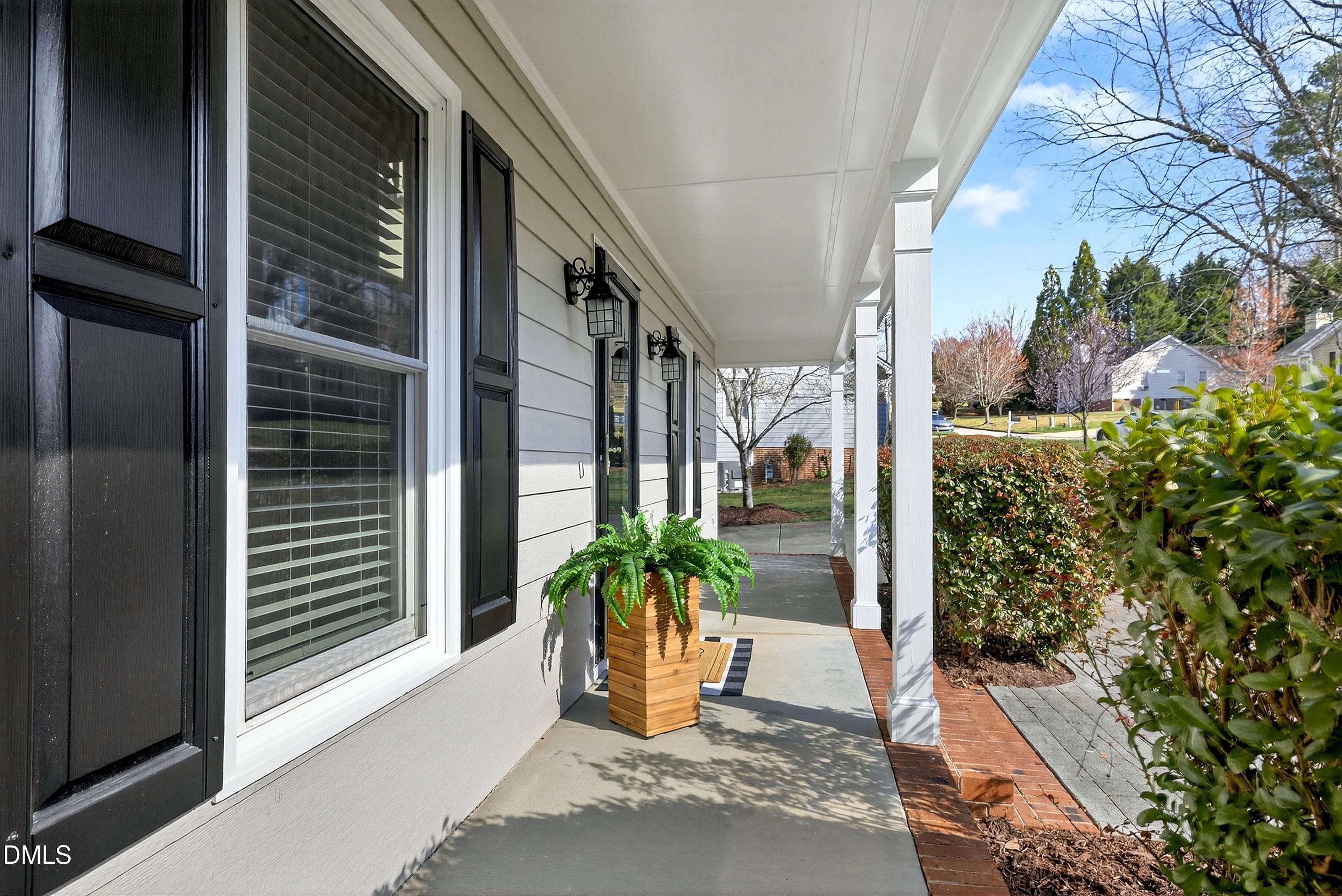 6009 Sweden Drive Raleigh, NC 27612 - Photo 3 of 38 a potted plant in front of a glass door