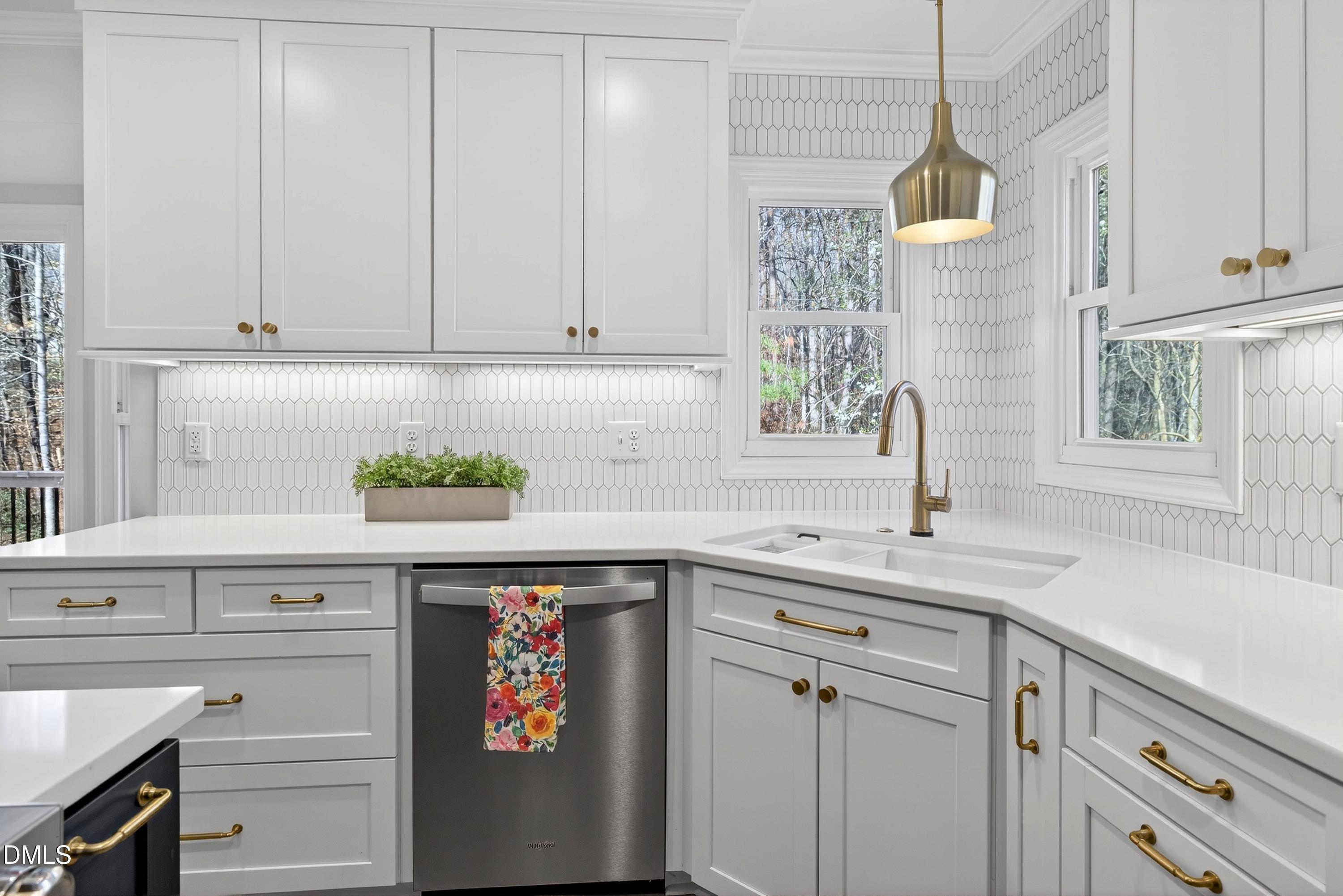 6009 Sweden Drive Raleigh, NC 27612 - Photo 9 of 38 a kitchen with granite countertop white cabinets and white appliances