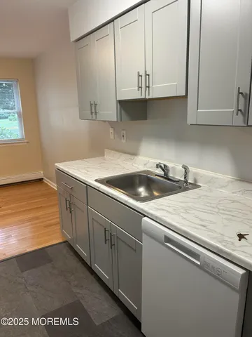 a kitchen with stainless steel appliances granite countertop a sink and a white cabinets