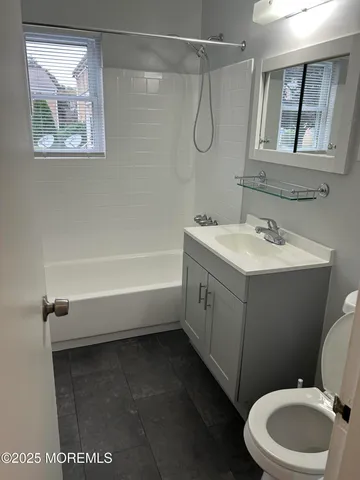 a bathroom with a sink a toilet and a bathtub