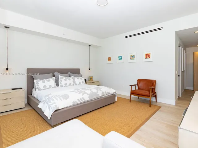 a bedroom with a bed and chair