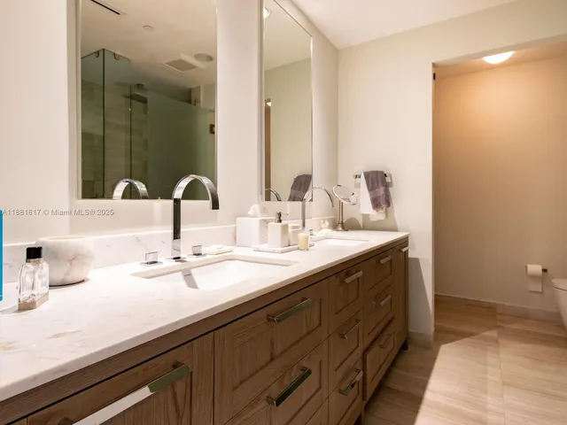a bathroom with a double vanity sink and a mirror