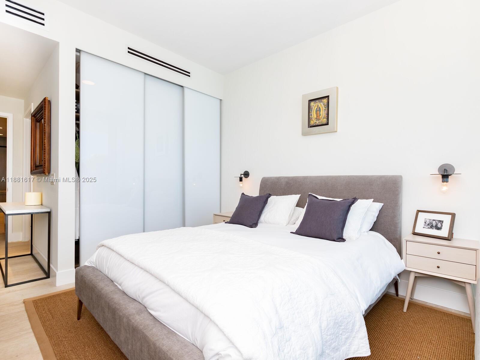 360 Ocean Drive, Unit 304S Key Biscayne, FL 33149 - Photo 21 of 40 a bedroom with a bed and a cabinets