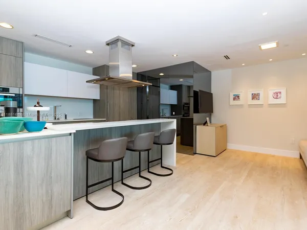 a kitchen with stainless steel appliances granite countertop a sink and a refrigerator