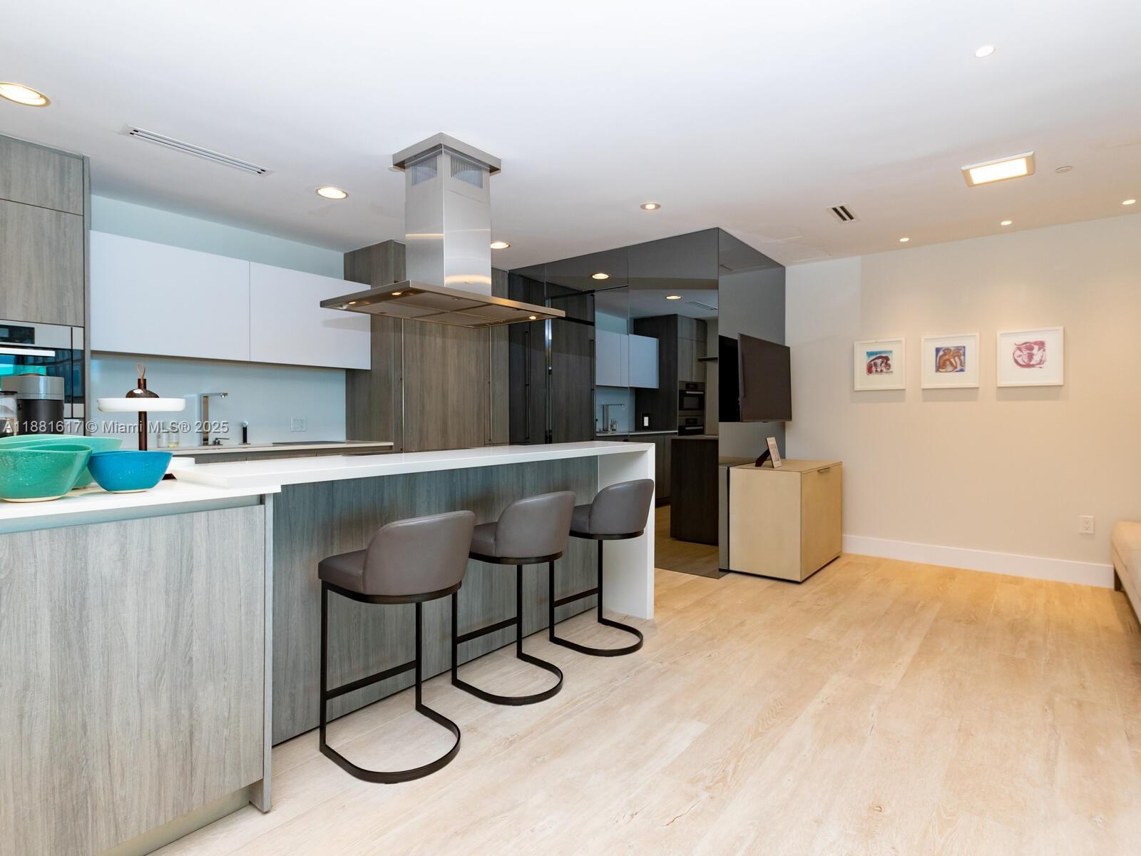 360 Ocean Drive, Unit 304S Key Biscayne, FL 33149 - Photo 28 of 40 a kitchen with stainless steel appliances granite countertop a sink and a refrigerator