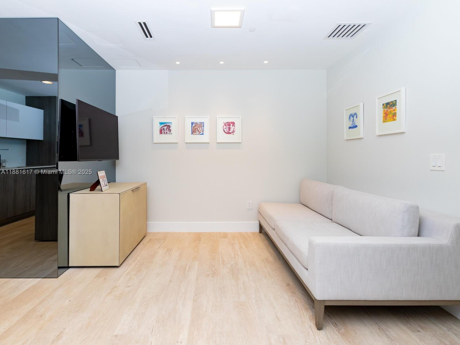 360 Ocean Drive, Unit 304S Key Biscayne, FL 33149 - Photo 29 of 40 a living room with furniture and a flat screen tv